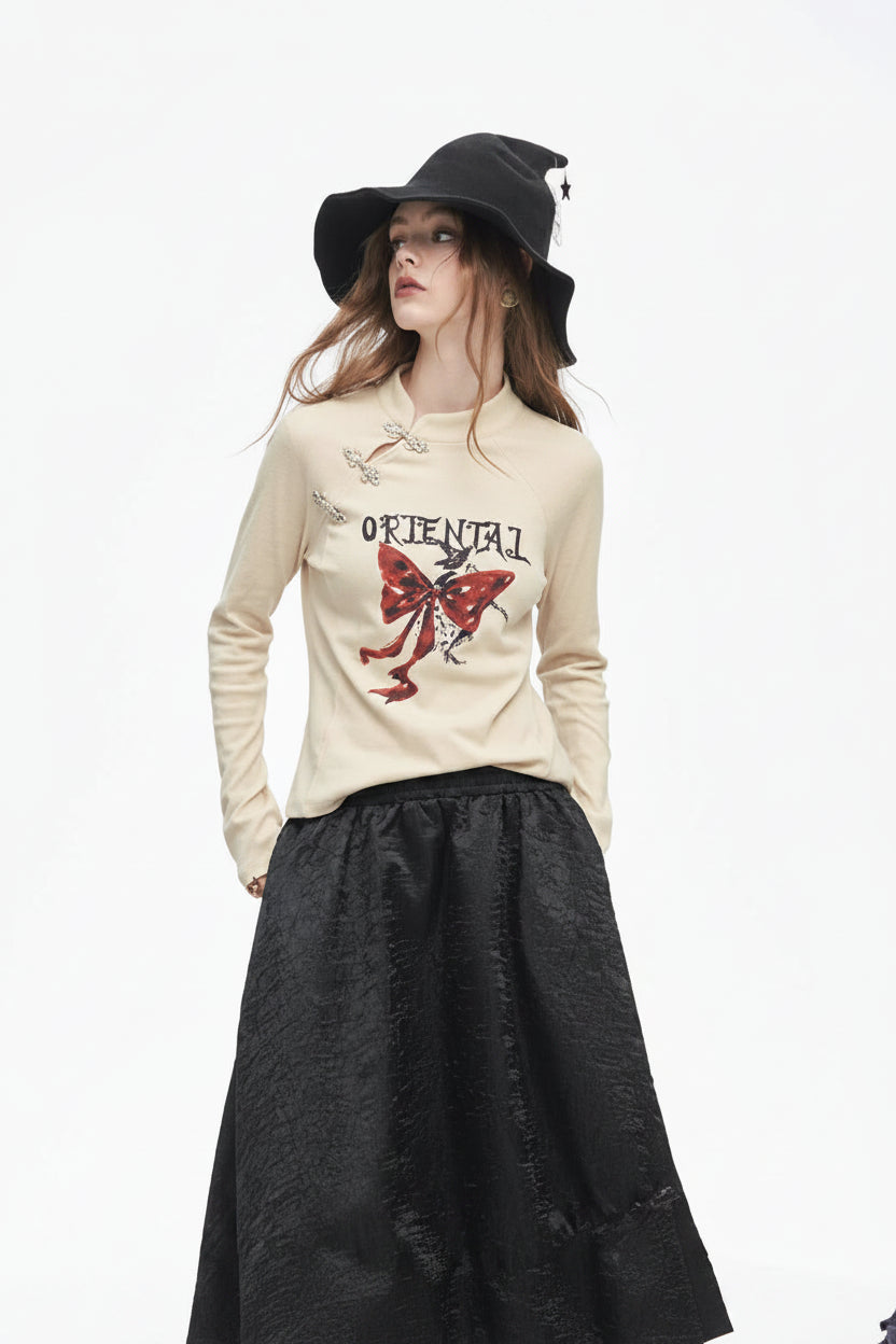ELFSACK 2025 Winter New Arrivals Y2K Chinese Style Irregular Button Collar Bow Graphic Long Sleeve Tshirt For Women