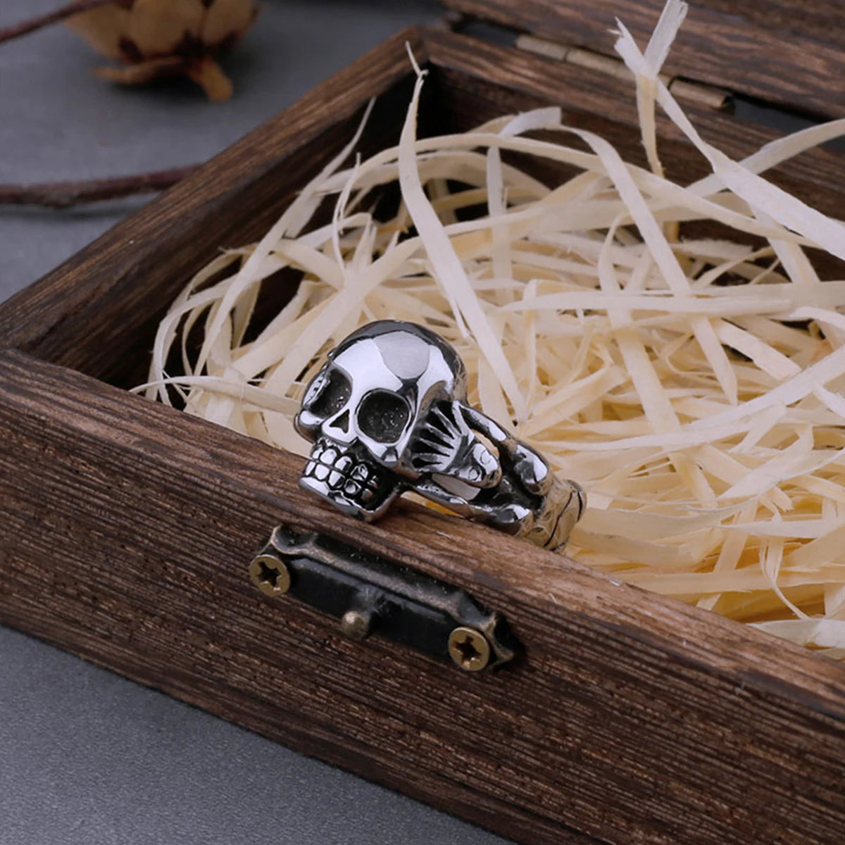 Hand Holding Skull Ring